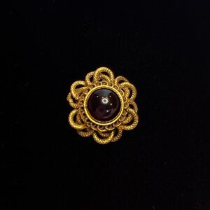 Antique Original by Robert.  Purple glass brooch.  1 1/2 inches in diameter.